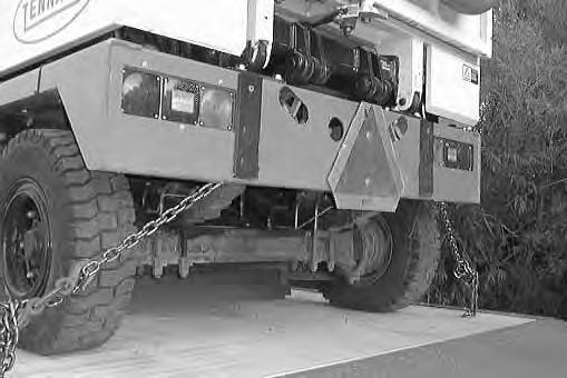 If the loading surface is not horizontal or is higher than 380 mm (15 in) from the ground, use a winch to unload machine.
