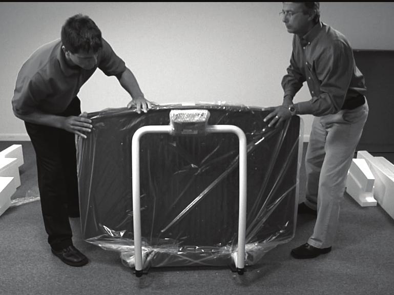 Using two people, remove the scale out of the packaging material that it came in by lifting the scale out of the box by the scale base as shown in Figure 3-2.