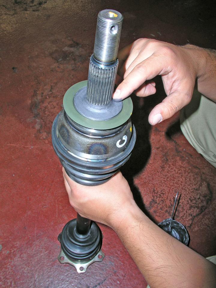 3. Clean the flange surface of the outer joint of the driveshaft and apply a moderate coat of Molykote M77 grease (see Figure