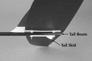 Insert the mounting bolts of the assembly through the holes from the top of the tail boom as shown in the