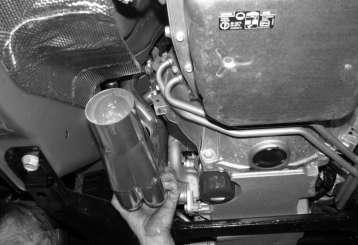 Figure 3: Insertion of driver s side header 11. Once the headers are held in by a couple of bolts, lower the car again. Proceed to insert the remaining manifold bolts. 12.