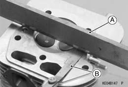 Cylinder Head Cylinder Head Inspection Lay a straightedge [A] across the mating surface of the head at several different points, and measure warp by inserting a thickness gauge [B] between the