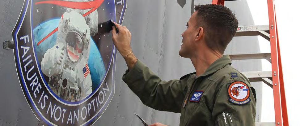As of today the A crew member applies a commerative decal on the side of a B-52H. The Air Force just recently restarted to allow nose art on bombers.