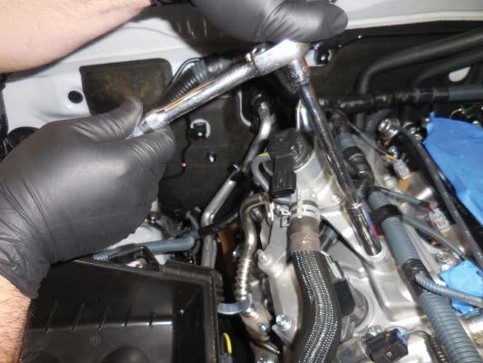 Thread the plugs in place using a socket and extension. Torque the spark plugs to 20 Nm (15 ft lbf).