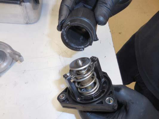 Gather the thermostat housing assembly that was removed earlier.