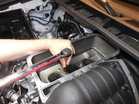 125. Torque the manifold bolts to 28 Nm (21 ft lbf) starting from the center and