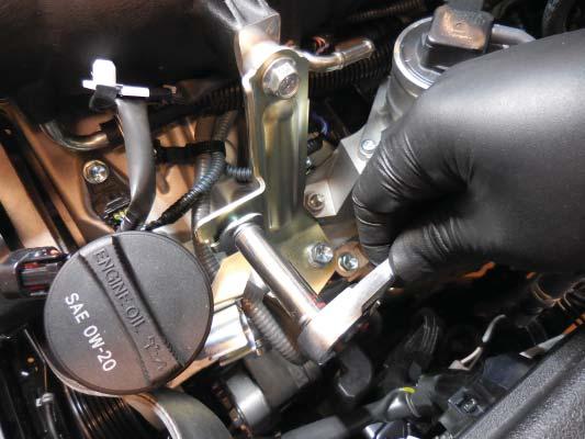 161. Remove the bolt shown at the left front supercharger