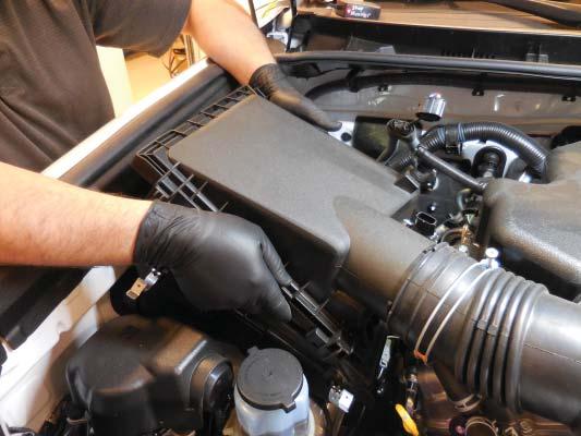 9. Remove the airbox lid and disconnect it from the