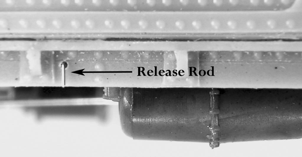 In others, there were brackets from which the release rod was hung (the bracket pictured here is strip styrene with a #79 hold drilled in it glued to the car side.