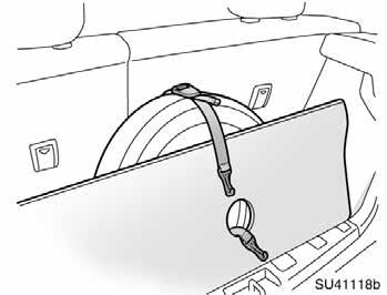 Pass one of the belt hooks through the center hole located on the wheel of the flat tire.