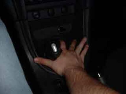 17. Plug the cigarette lighter back in, and slide the boot cover back over the shifter handle.