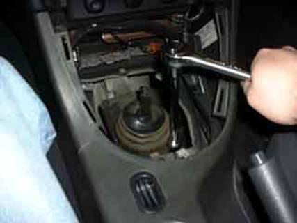 5. Using a 13mm socket and extension, remove the four bolts holding the stock shifter on the transmission. 6. Pry off the shifter.