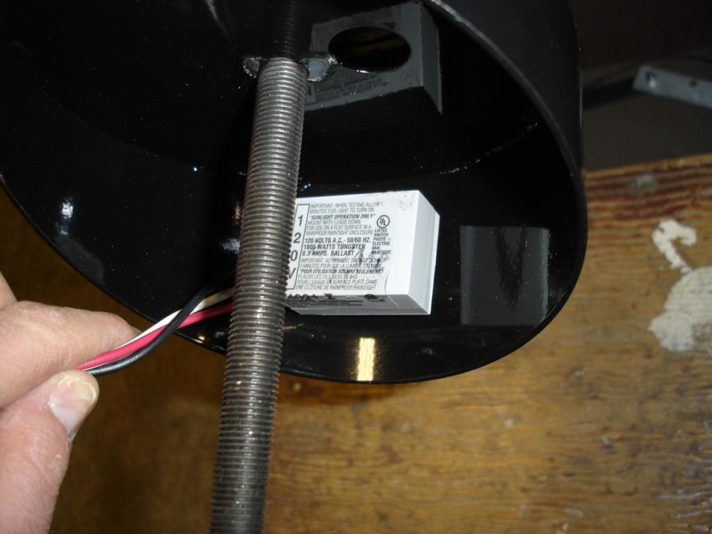 Remove light sensor from station by unscrewing the three wire nuts and the plastic