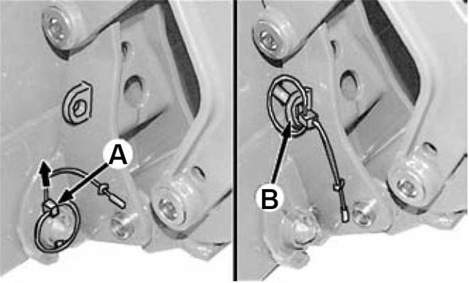 Drive forward, adjusting loader height and position until the top of the loader bracket engages the hooks (C) on the Snow Pusher. 3.