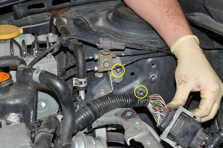 Guide the lower coolant hose underneath the main wire harness while installing the AOS.
