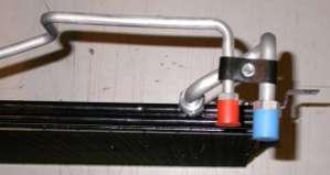 Locate the tube support clamp assembly and attach to the tubes as shown.