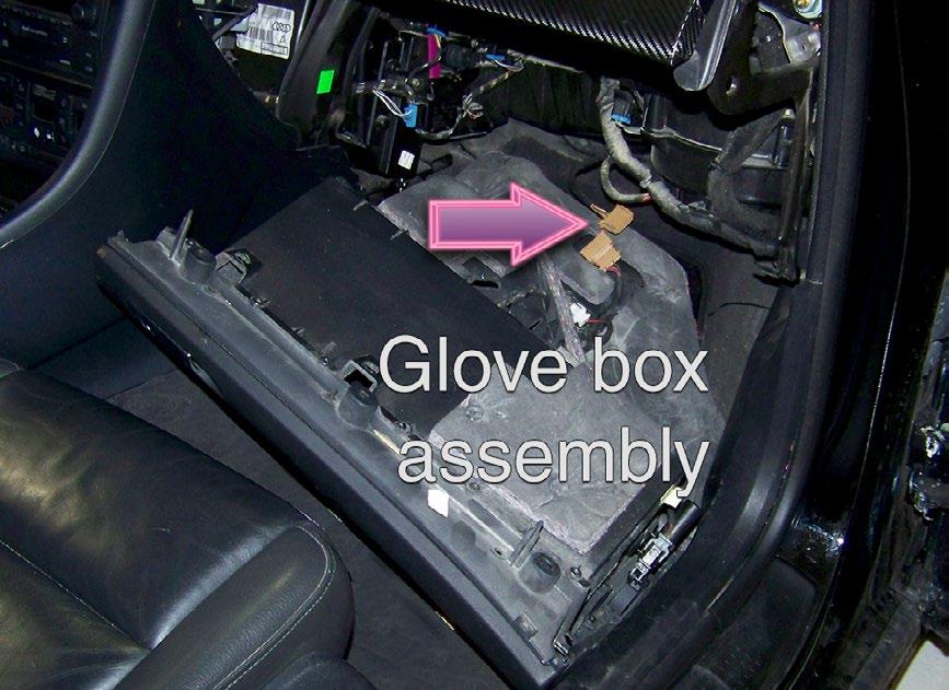 ) The mating screw is located at the opposite (left) lower edge of the glove box.