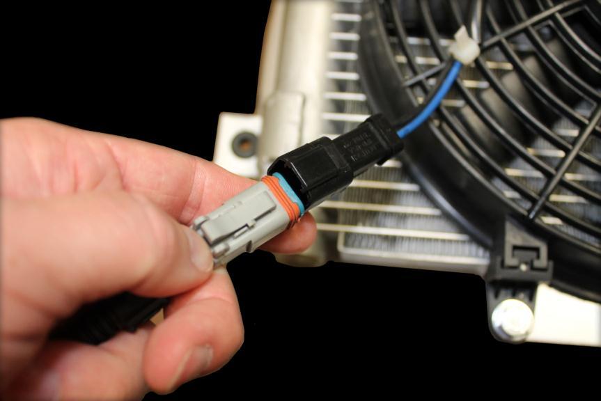 20) Under vehicle insert two pin connector on harness into fan motor connector, then connect harness to temperature