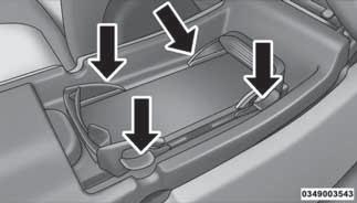 4. Adjust the wireless charging pad mobile phone cradle to hold the mobile phone in position. The cradle moves by pushing down on the finger tabs and adjusting the cradle in or out.