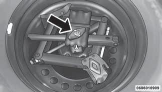 Lower the vehicle to the ground by turning the jack handle counterclockwise. 11. Finish tightening the wheel bolts. Push down on the wrench while at the end of the handle for increased leverage.