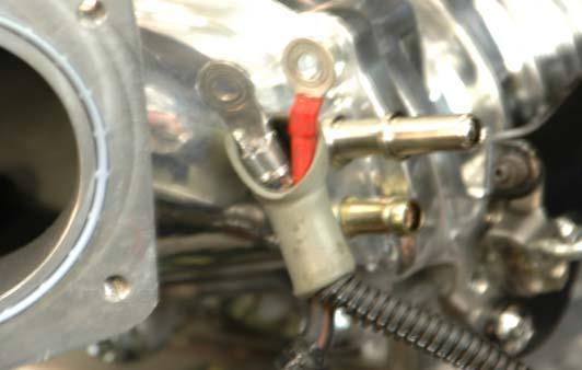 93. Locate the new intercooler wiring harness and pass the red power connection under the boot of the alternator cable