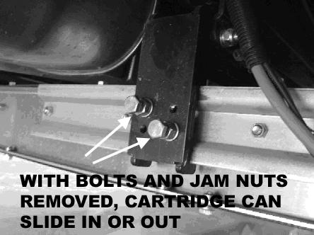 Refer to Figure 3. To adjust the in and out position of the platform, remove the jam nuts and bolts that secure the enclosure slides.