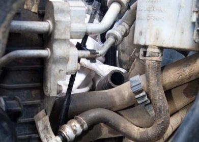 If you have an automatic gearbox, remove and plug the two oil pipes that go to the right hand side of the radiator. Some oil will probably come out of the pipes.