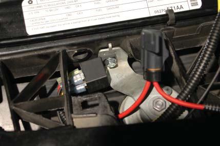 97. Use a 10mm wrench to remove the bolt from the passenger side horn mount.