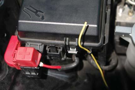 Remove the existing nut from the positive (+) stud exposed when you removed the red wire cover.