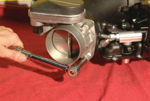 Use the provided throttle body bolts to mount the throttle body on the new intake.