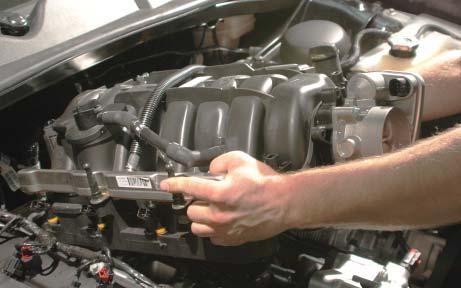 Pull the OEM intake manifold forward a bit to gain access to the