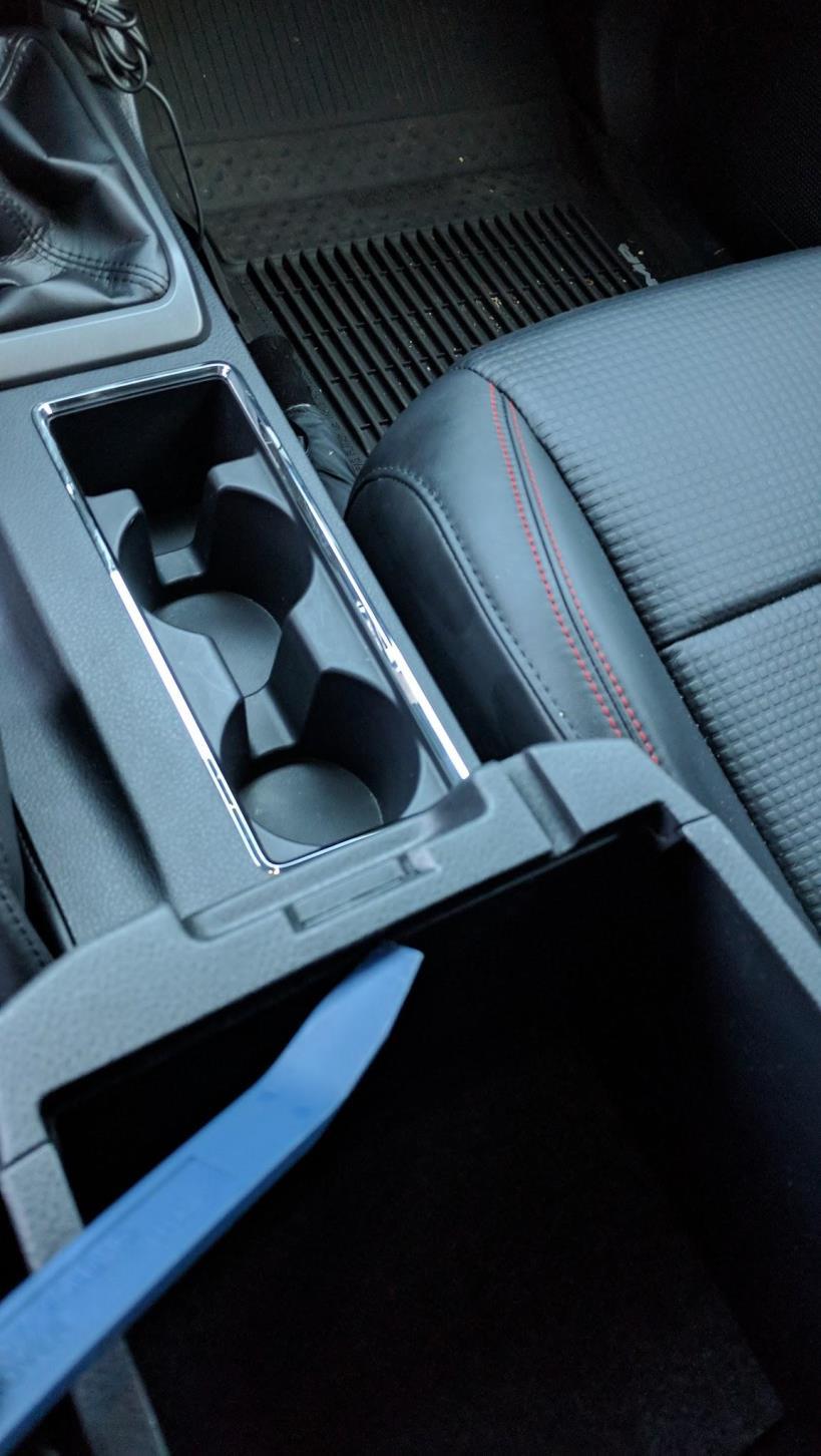 MANUAL SHIFT BOOT Use the trim removal tool to pry the center console edge in the armrest storage as shown in pictures