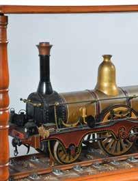 The model finished in traditional livery and set on a display track in its original glazed mahogany display case having turned corner columns on bun feet with removable top.