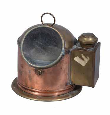 151 A life boat compass, in polished brass and copper case with observation glazed panel and burner compartment. Height 25cm.