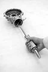 Remove the snap ring. Remove the pinion gear pilot bearing by using the special tools.