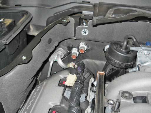 Disconnect the heater feed and return hoses located at the