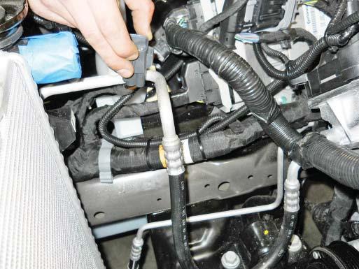 9. Route the intercooler pump wire harness over the top and in