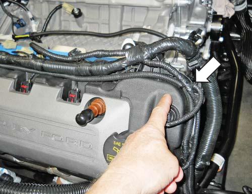 Route the intercooler pump wire harness over the top and in front of the wiper washer bottle. Secure it in place with zip ties as necessary. 9.