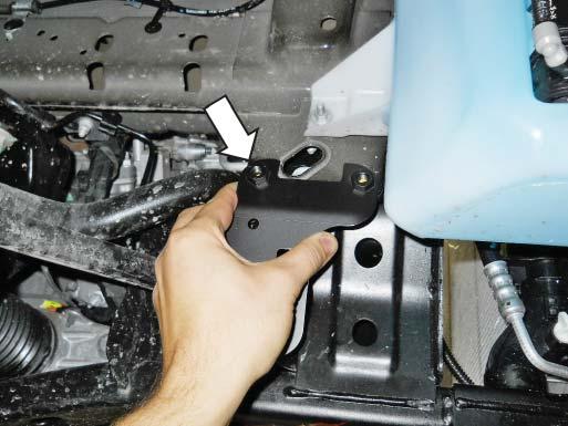 against the frame behind the wiper fluid reservoir mounting bracket as shown.