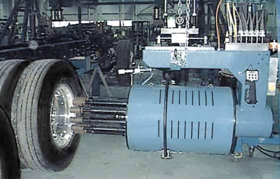 Shown here is a five spindle wheelnut tool mounted to an overhead suspension system. The suspension system is mounted to an overhead track.