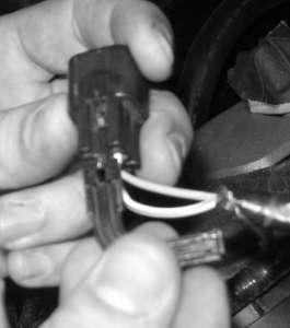 Locate the Canister Purge Valve electrical connector at the front of the passenger side cylinder head.