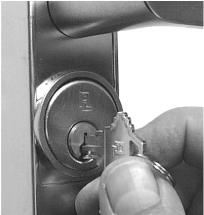 Insert key half-way into the cylinder, then screw it in. See Fig. 1a. If cylinder will not seat flush, the cylinder back stop screw may require loosening.