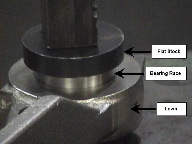 Using a flat piece of stock to protect the bearing,