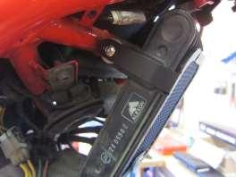 Remove the three bolts that secure the plastic oil cooler surround in place, as