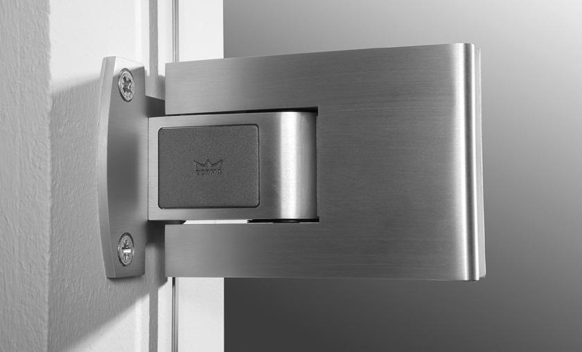 In the case of a "glass-to-glass" model, the doubleacting door is hung from the sidelite. The TENSOR hinge features a slightly convex, curved form, with an inlay that serves as a mechanical stop.