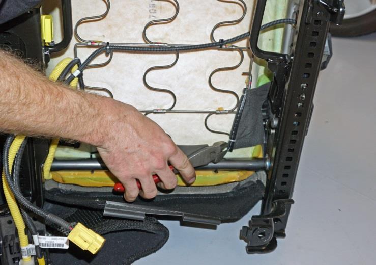 Use a pair of side cutters to remove two (2) hog rings (G) from the right side seat