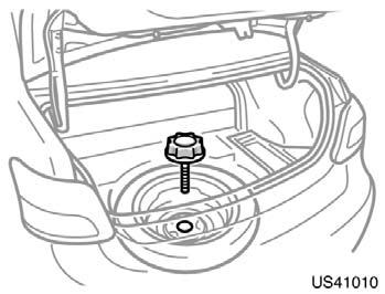 Blocking the wheel Removing wheel ornament (on some models) US41010 US41001 PS41507 To remove the spare tire, loosen the bolt and remove it. Then take the spare tire out of the vehicle.