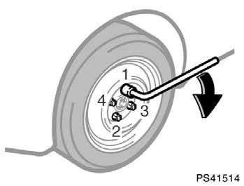 Lowering your vehicle PS41514 9. Lower the vehicle completely and tighten the wheel nuts. Turn the jack handle counterclockwise to lower the vehicle. Use only the wheel nut wrench to tighten the nuts.