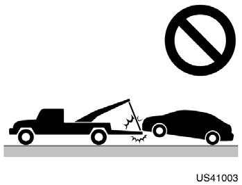 (c) Towing with sliding type truck US41003 (c) Towing with sling type truck NOTICE Do not tow with sling type truck, either from the front or rear. This may cause body damage.