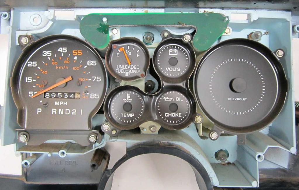 Remove the factory gauges by removing the screws shown in the